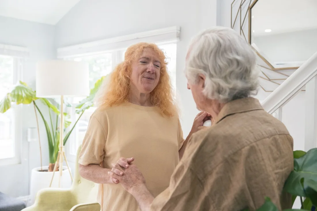 Home 2 Senior couple holding hands and smiling together